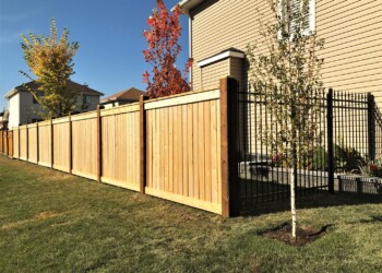 Ornamental fence attached to wood fence